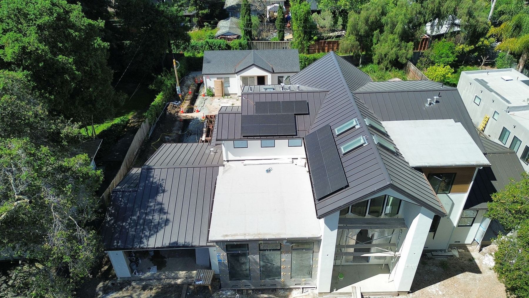 Dark metal roof with integrated solar panels — Bay Area roofing project