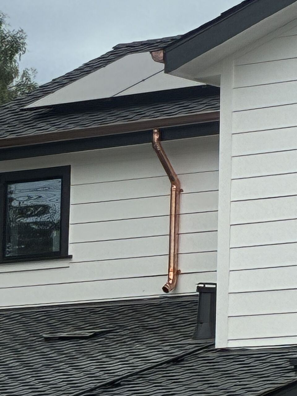 Copper downspout roof-to-roof detail — new construction