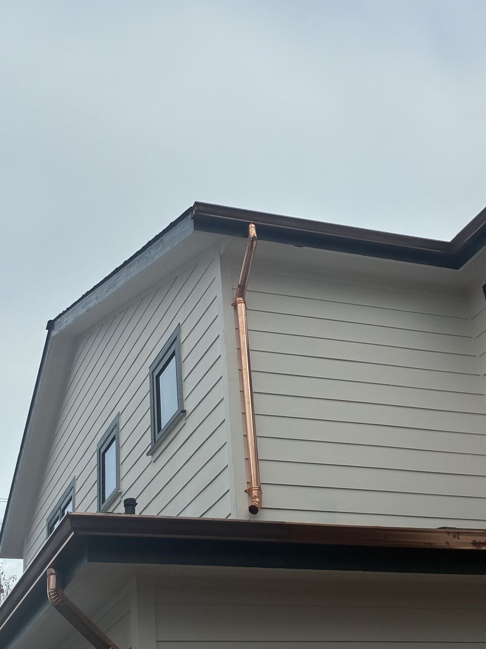 Custom-formed copper gooseneck elbow on downspout transition