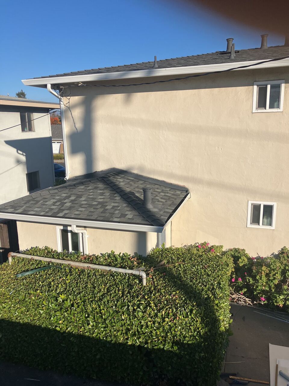 Rear laundry-area bump-out with new Landmark shingle roof tied into the main building