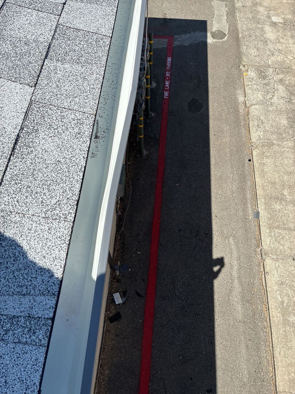 New gutter run along the fire-lane street side of the apartment building