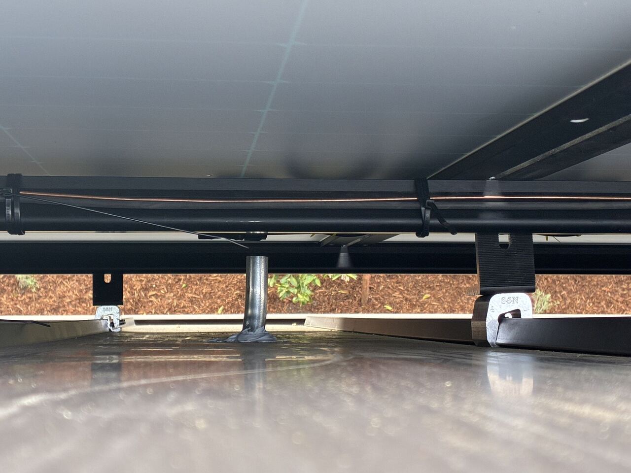 S-5 non-penetrating clamps attaching solar racking to standing seam panels without roof penetrations