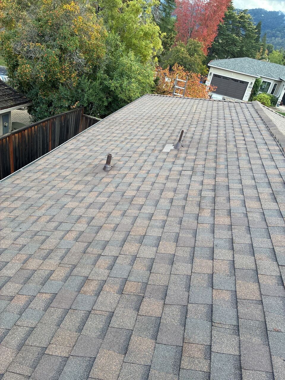 Finished Landmark shingle field with color-matched pipe boots and Santa Cruz foothills in the background