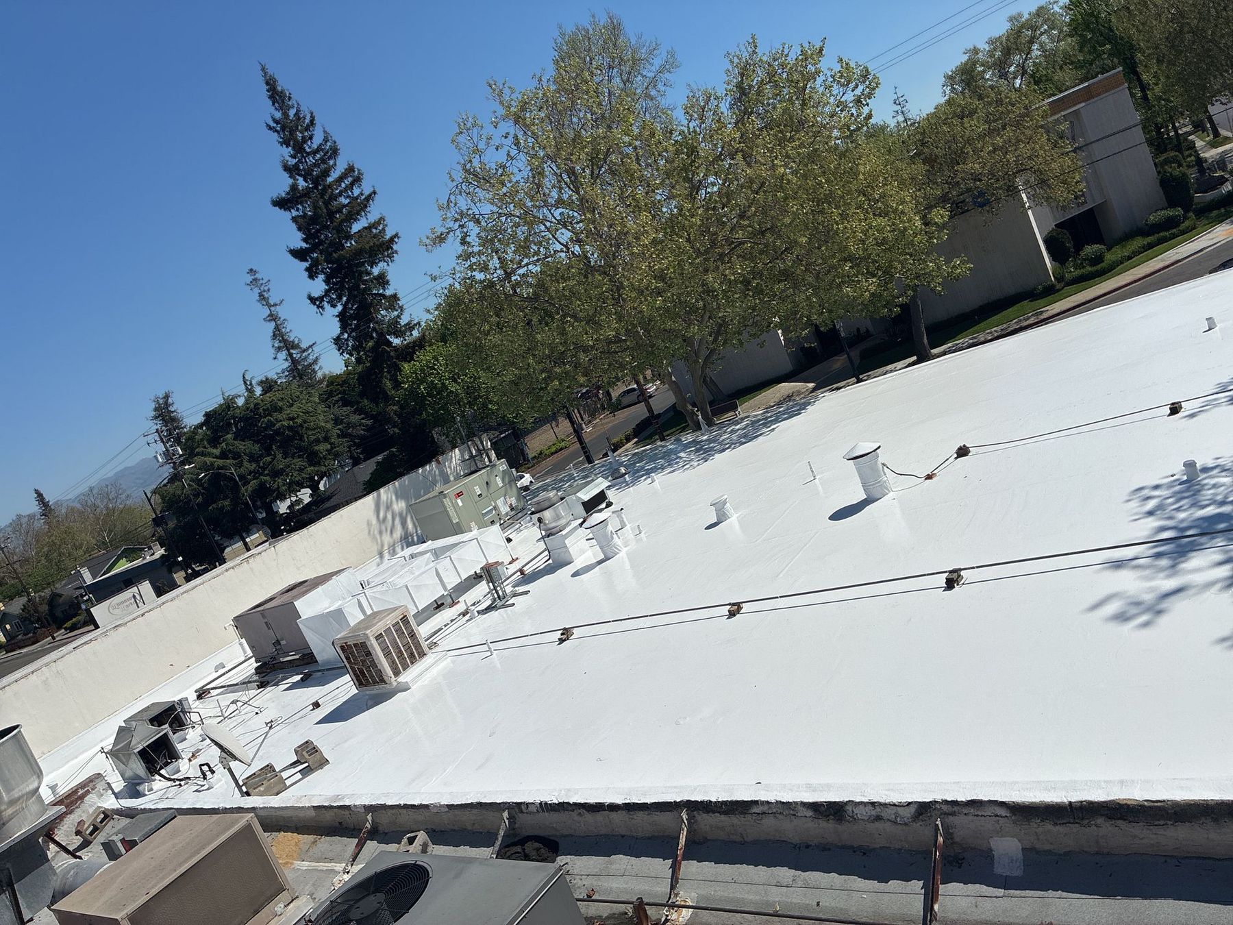White silicone roof coating on a San Jose commercial building by Keith Roofing